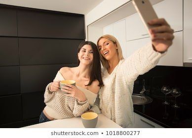 Blonde lesbian in yellow kitchen